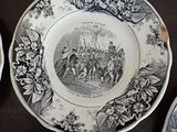 several plates with black and white designs on them on a table