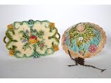 two decorative dishes are sitting on a white surface