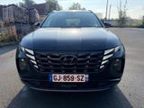 the front view of a black car parked in a parking lot