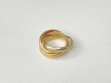 a close up of a gold ring on a white surface