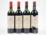 three bottles of wine are lined up on a white surface