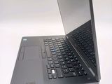 a laptop that is open on a white surface
