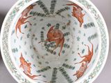 a bowl with a deer design on it sitting on a table