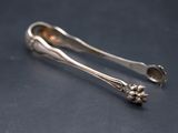 two spoons that are sitting next to each other on a table