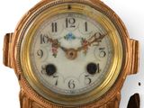 a gold clock that is sitting on a white surface