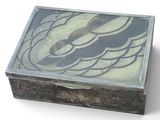 a wooden box with a design on it on a white surface