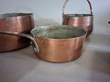 two pots and a spoon sitting on a table