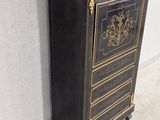 an antique black and gold chest of drawers with a marble top