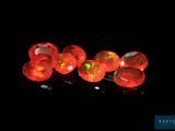 several red fire oplite beads are lit up in the dark