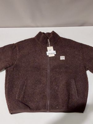 the jacket is brown and has a white tag on it
