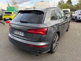 the rear of a gray audi suv parked in a parking lot