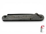an old black pocket knife with the name of a man on it