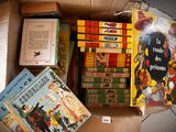 many books in a box that are sitting on top of each other