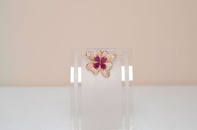 crystal butterfly brooch with pink stones on clear acrylic stand