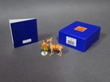 a small figurine of a man riding a horse in a cart