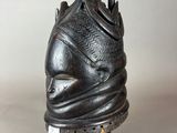 a close up of a statue of a head with a crown on it