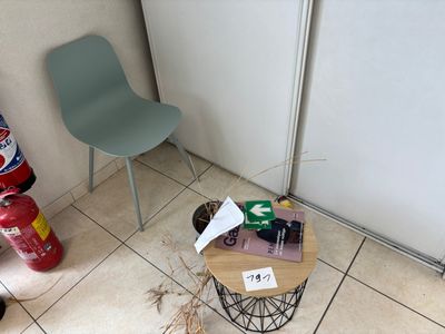 a chair and a table in the corner of a room