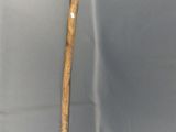 a stick with a bird head on it sitting on a table