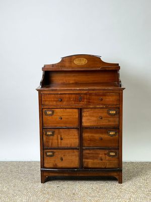 an old wooden dresser with a mirror on top of it