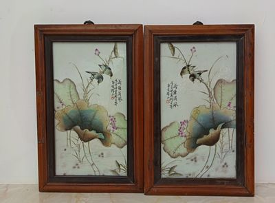 two framed pictures of birds and flowers on the wall