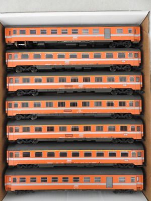 a lot of train cars in a box on the table