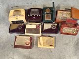 many old radio ' s that are sitting on the floor