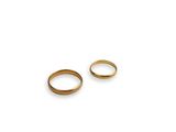 a pair of gold wedding rings on a white background