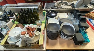 many plates and bowls sitting on a table in the kitchen