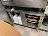 a kitchen with a sink and a stove in it