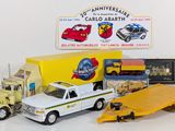 a toy truck with a flatbed trailer and other toy vehicles