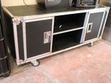 a black and silver entertainment center with a television on top of it