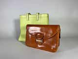 two brown and green bags sitting next to each other on a table
