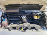 the engine of a car with its hood open and the hood down