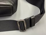 a black bag that has a metal buckle on it