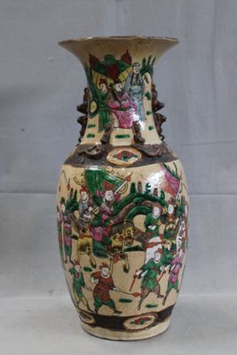 a vase with a painting on it sitting on a table