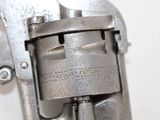 a close up of a gun on a white surface