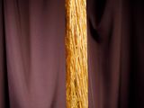 an image of a tall yellow vase with a black background