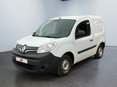 the white van is parked in a large room with a black floor