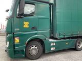 a green semi truck parked in a parking lot