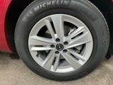 the tire of a red car with a michel tire on it