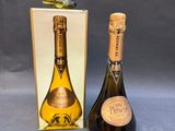 an image of a bottle of champagne next to a cardboard box