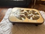 a coffee table with a mosaic design on top of it