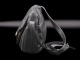 a black purse that is sitting on a black surface