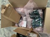 a cardboard box filled with assorted electronics and other items
