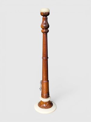 an image of a tall wooden candle holder with a white marble top