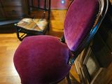 a purple chair sitting in front of a fireplace in a living room