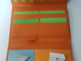an orange leather wallet with a picture of a dolphin and a picture of a dolphin