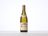 the bottle of white wine is sitting on the table