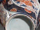 a blue and white teapot with a floral design on it