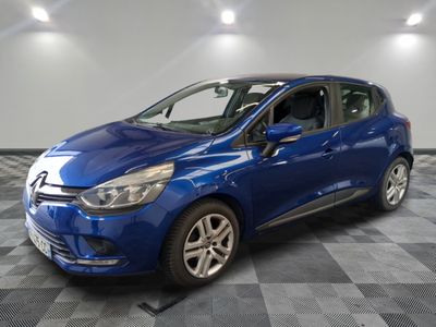 a blue car parked in a garage with a checkered floor